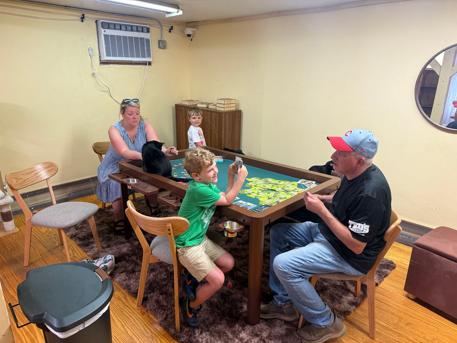 Family enjoying a board game on a wooden gaming table at home