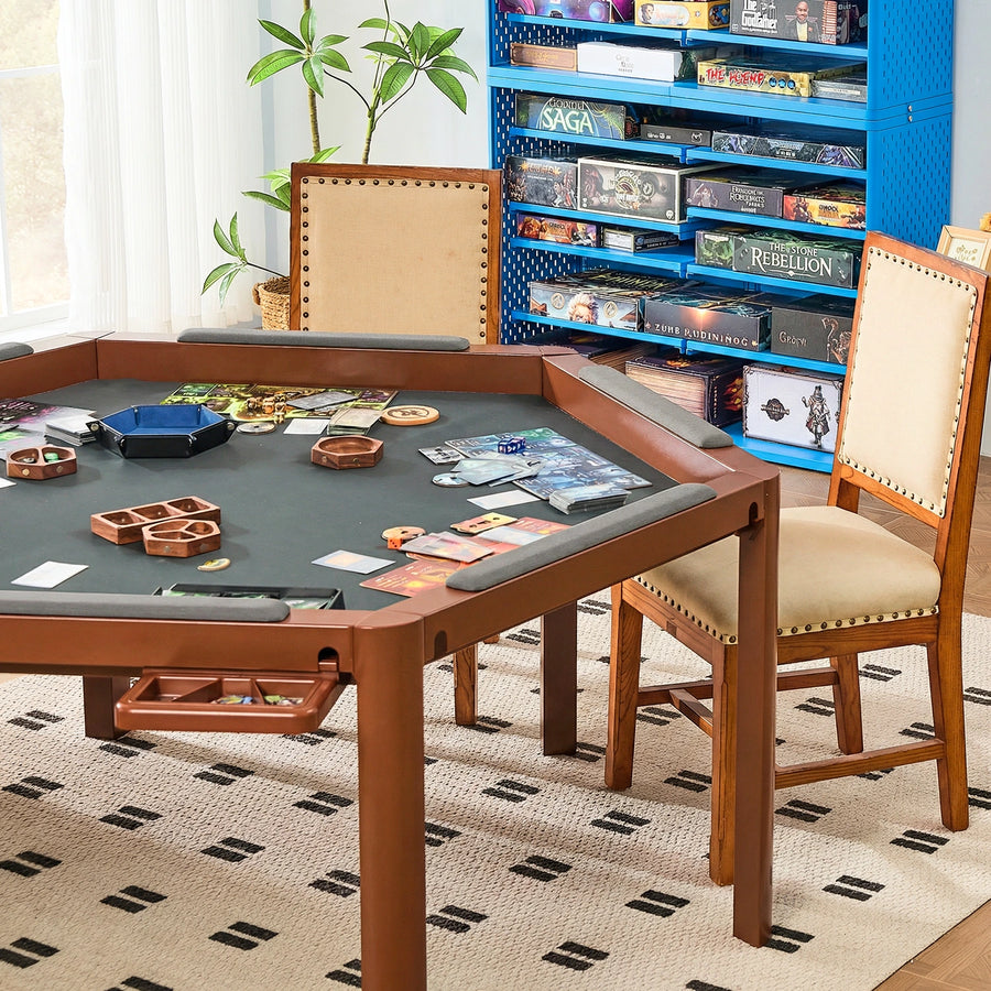 Brown Ironside gaming table with gray memory foam armrests, surrounded by board games and a wooden chair.