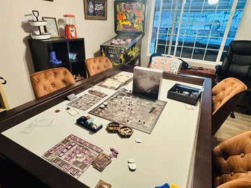 A board game setup on a large dining table