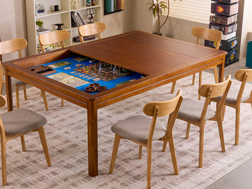 A wooden rectangular game table with gray upholstered seats in a styled room.