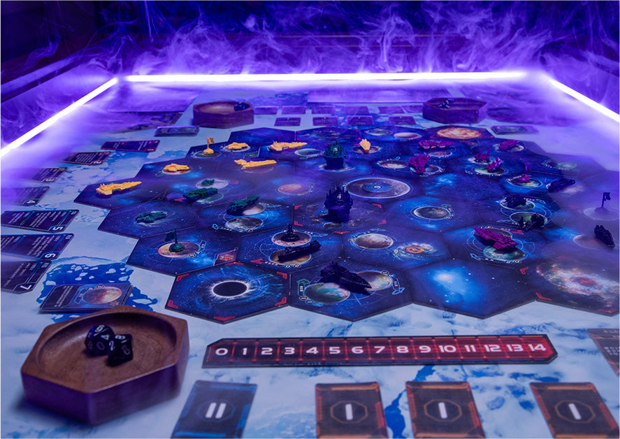 Illuminated hex-tile space-themed board game setup with miniatures and purple LED lighting on gaming table | BoxKing Gaming