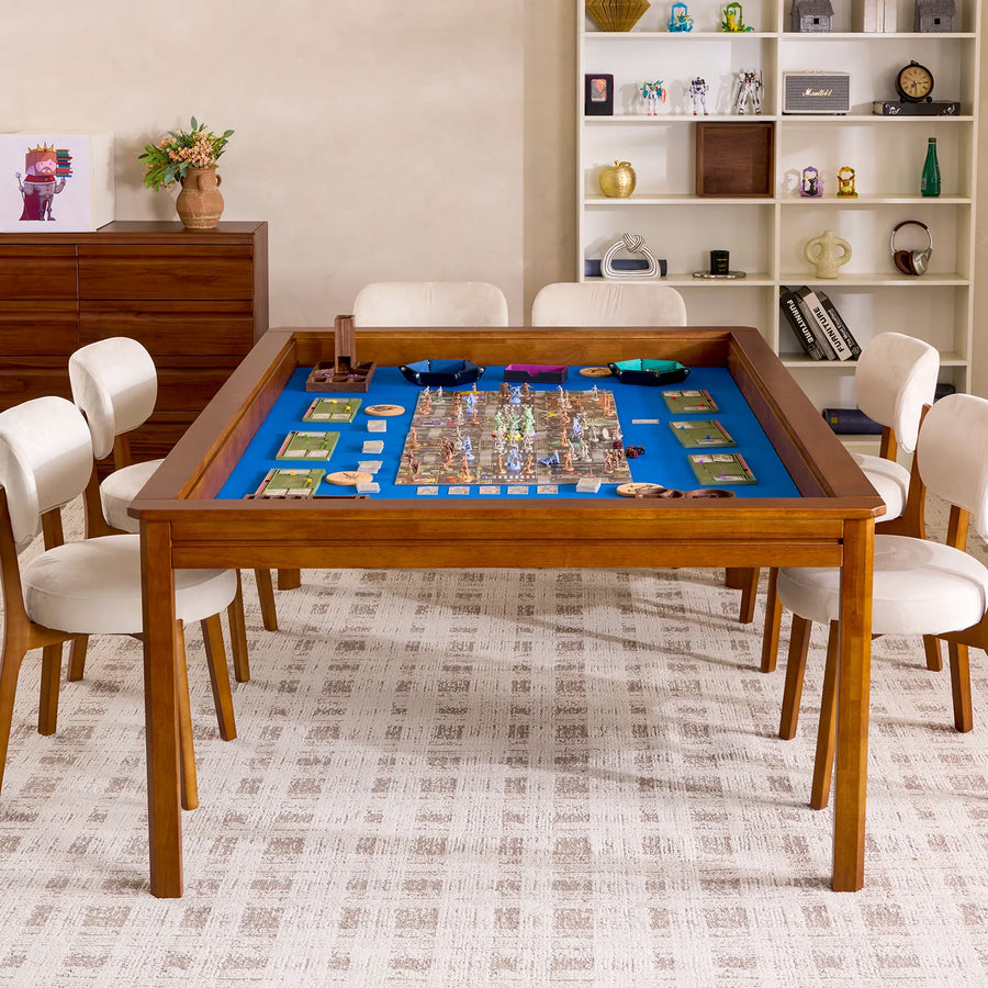 Kingswood 4x6' rubberwood game table with blue playing surface, surrounded by white chairs.